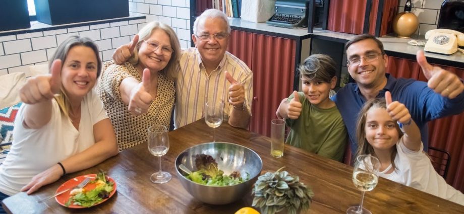 A happy family enjoying a meal together, showcasing togetherness and joy at a dining table.