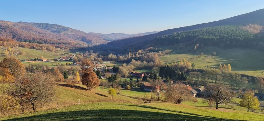 a scenic view of a valley in the mountains